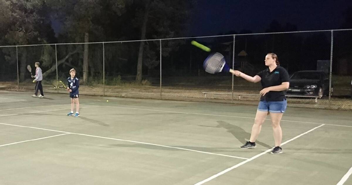 TOP SPIN: Midgees' Andrew White and Gyselle Anderson team up in doubles during Coleambally Summer Tennis.