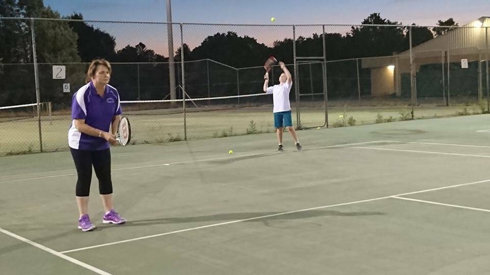 BASELINE: Paula Clarke and Daniel Collier take on the competition at the Coleambally Summer Tennis competition.