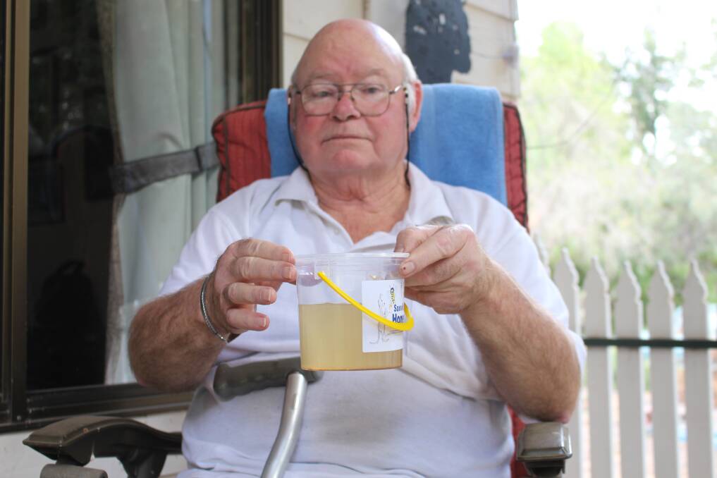 DIRTY WATER: Concerned Darlington Point resident James Tougue shows off the discoloured liquid coming from his taps.