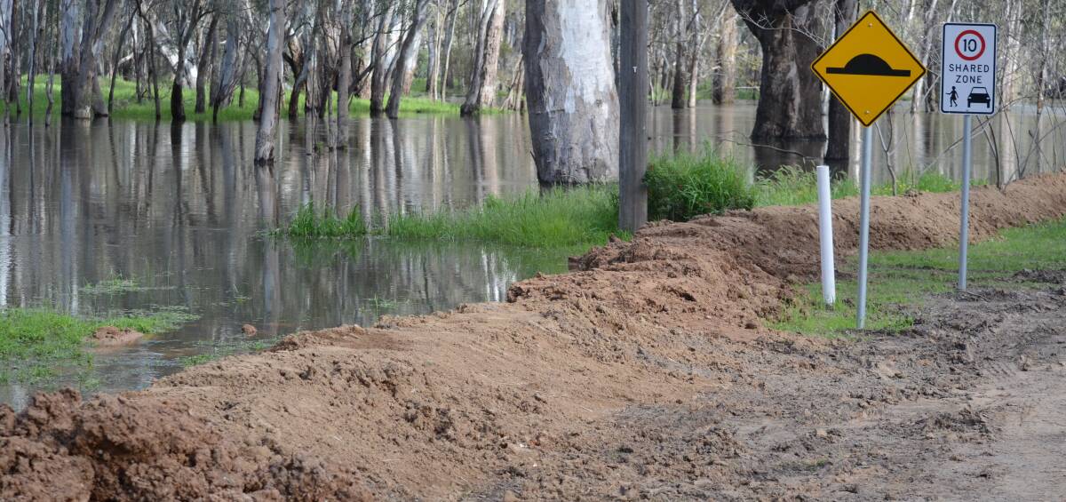 Water everywhere: The Darlington Point Caravan Park has been well protected by a dirt levee. Picture: Liam Warren 