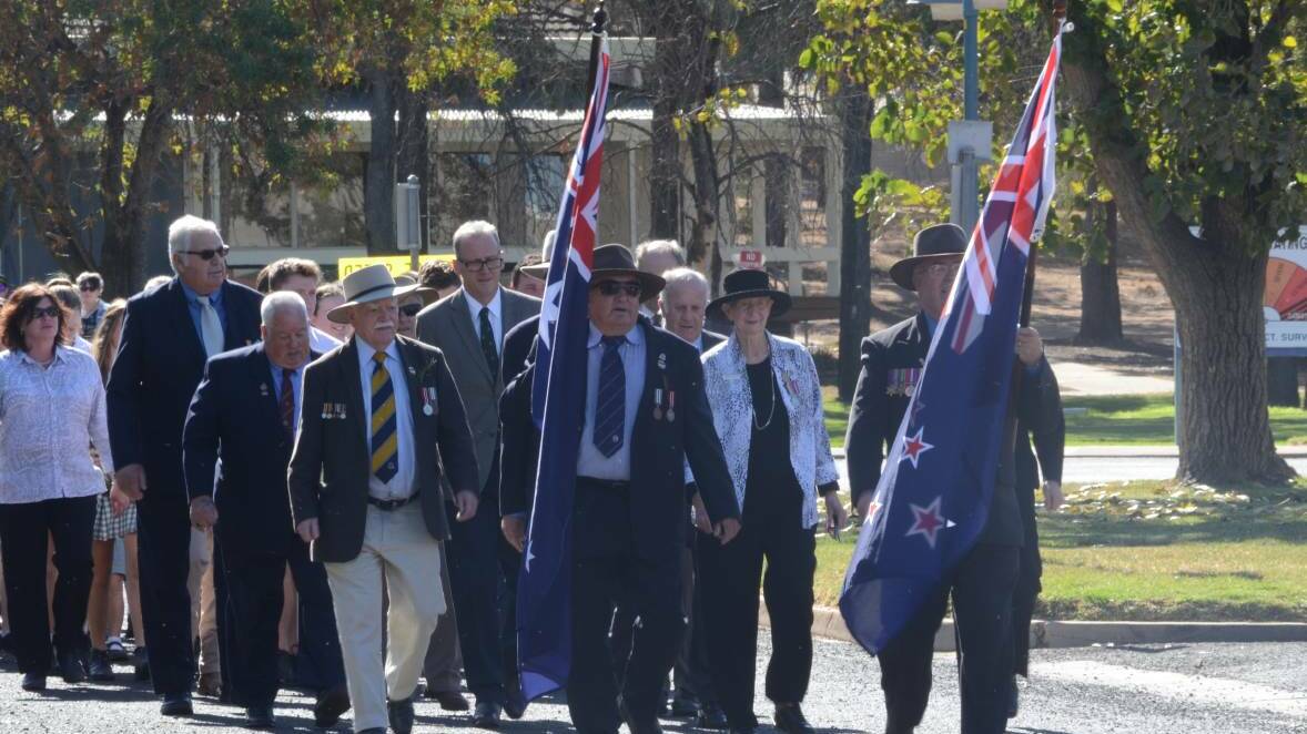 PAYING RESPECTS: Coleambally residents march through the streets as part of last year's ANZAC Day observances.