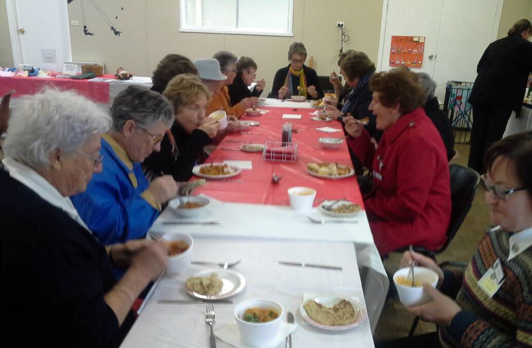 ENJOY: CWA members enjoy a feast for international day recently. Picture: Contributed