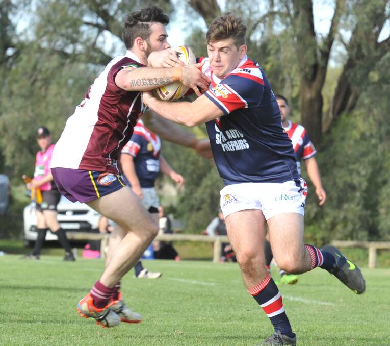 TOUGH AS NAILS: John Briggs with beautiful fend-off against the Hawks on Sunday. Picture: Riley Krause. 