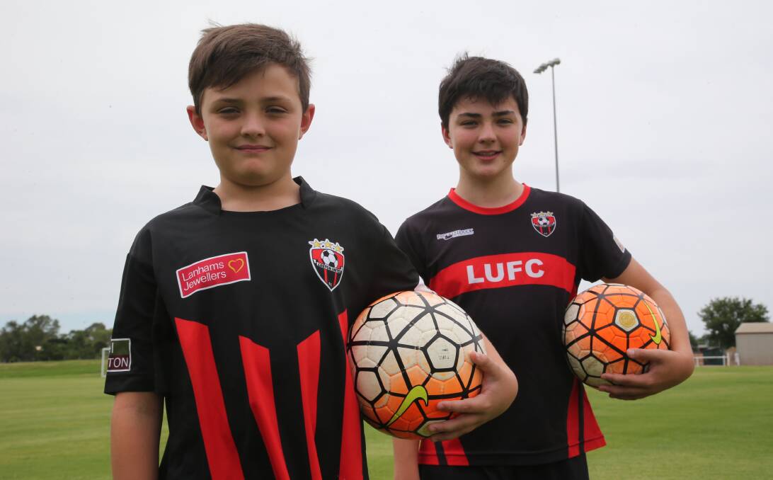 EXCITED: Oliver, 10, (front) and Jack Kidd, 12, are eager to participate in this weekend’s Arsenal soccer holiday camp, which will be held in Leeton at the town ovals. Photo: Anthony Stipo 