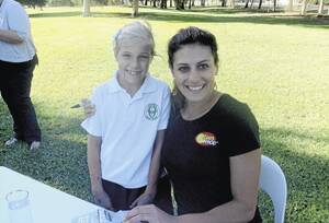 BRUSH WITH FAME: Coly Central School pupil Millie Rossato with Australian swimming’s golden girl, Stephanie Rice, in Leeton last week.