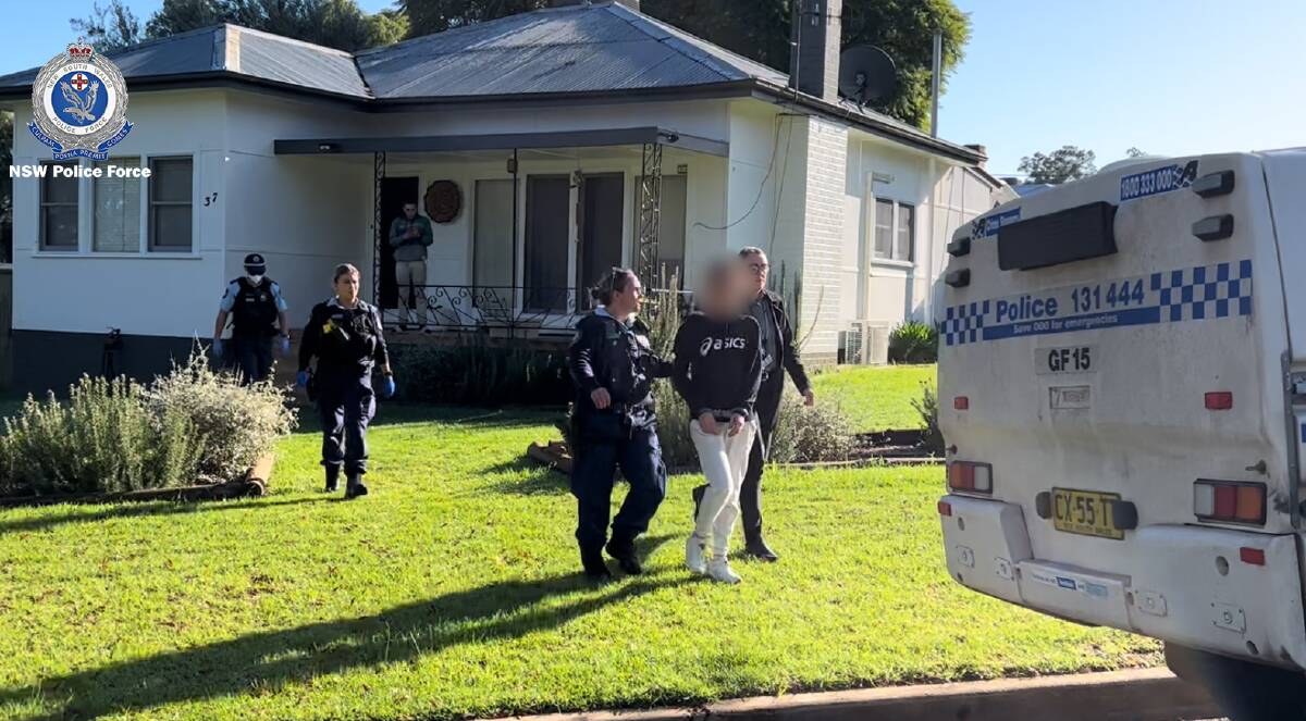 ARREST: A 31-year-old woman was escorted from her house and taken to Griffith Police Station, where she was charged with multiple felonies. PHOTO: Contributed
