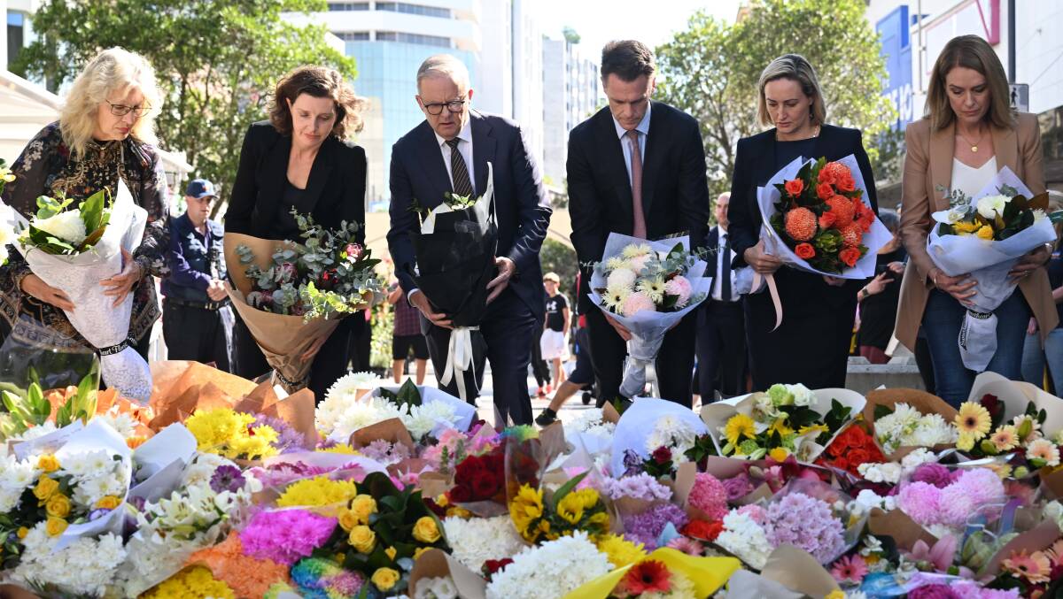 Australian Prime Minister Anthony Albanese (centre left) and NSW Premier Chris Minns (centre right) join other politicians as they lay flowers at the scene of yesterday's mass stabbing. AAP Image/Dean Lewins