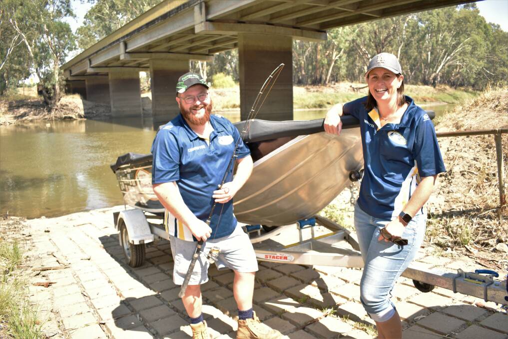 GONE FISHING: Matthew Lashbrook and Jeanice McCosker with the one of the prize fishing boats up for grabs. The major raffle will be drawn on February 9, and all proceeds will go to Rural Outreach Counselling. PHOTO: Kenji Sato
