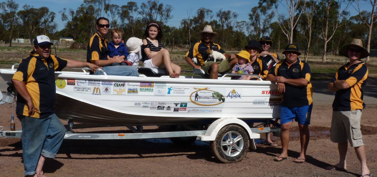 TOP PRIZE: Riverina Classic Catch and Release committee members with one of the boats on offer.