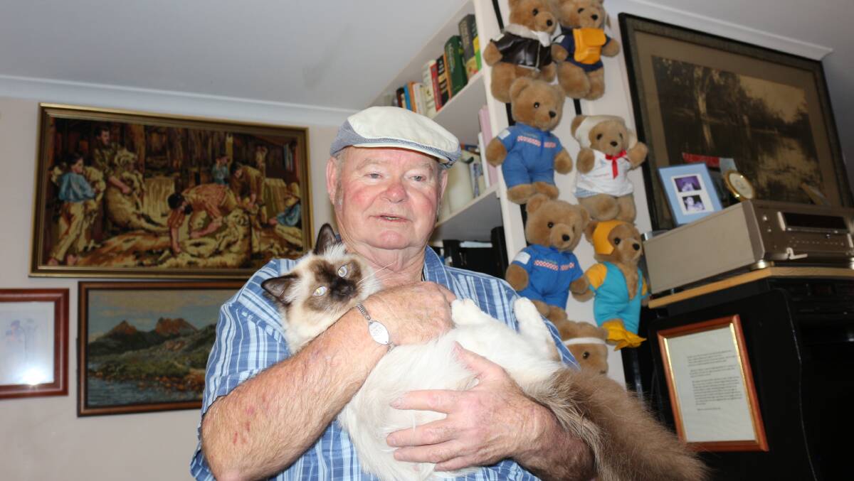 Cat trapper: James Tongue with his beloved pet house cat Sunshine, Mr Tougne has been trapping feral cats in Darlington Point for 20 years. Picture: Reuben Wylie 