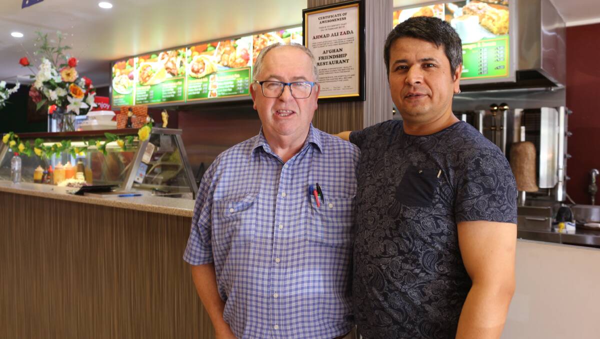 FAMILY: Coly resident Terry Inglis and Ahmad Ali Zada share a hug at the Afghan Friendship Restaurant. PHOTO: Kenji Sato
