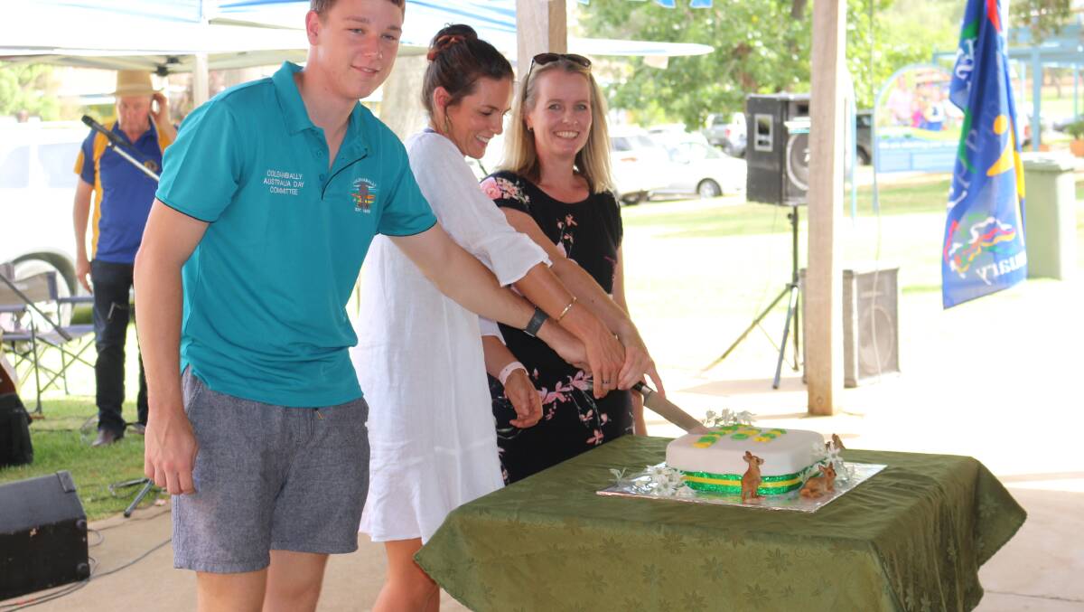 Australia Day: Thomas Breed, Ginny Stevens and Catherine DeMamiel cut the cake at John McInnes Square on Saturday morning. Picture: Reuben Wylie