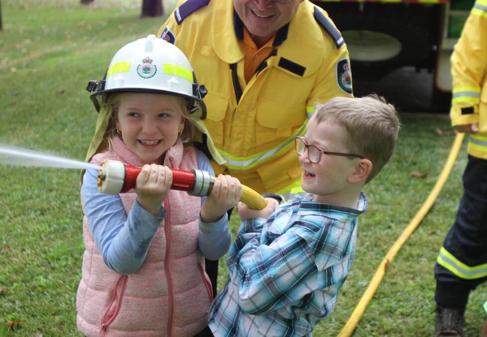 GOOD FUN: Breanna and Hayden Witham enjoyed the RFS display at the celebrations to mark Coleambally's 50th anniversary. PHOTO: Jessica Coates