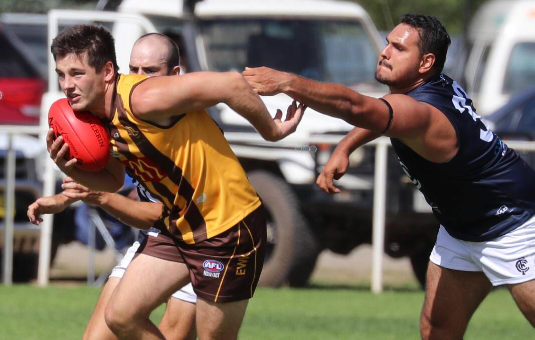 DEFENCE INTO ATTACK: East Wagga-Kooringal's Nick Curran looks to break free of Dwayne Weetra as the Hawks shut down the Blues on Saturday. Picture: Les Smith