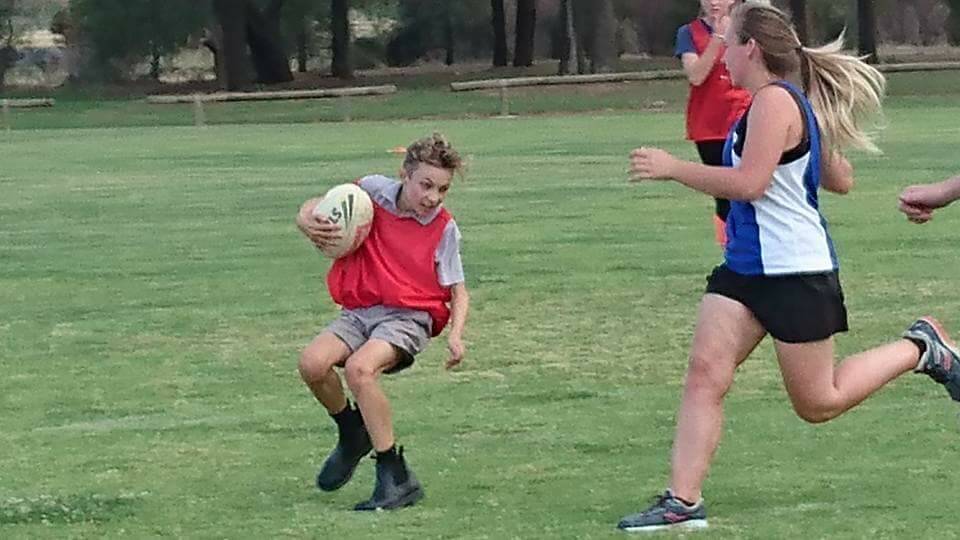 DUCK AND WEAVE: Joe Rossato dodges past his opposition during the Coleambally junior touch competition. Picture: Contributed