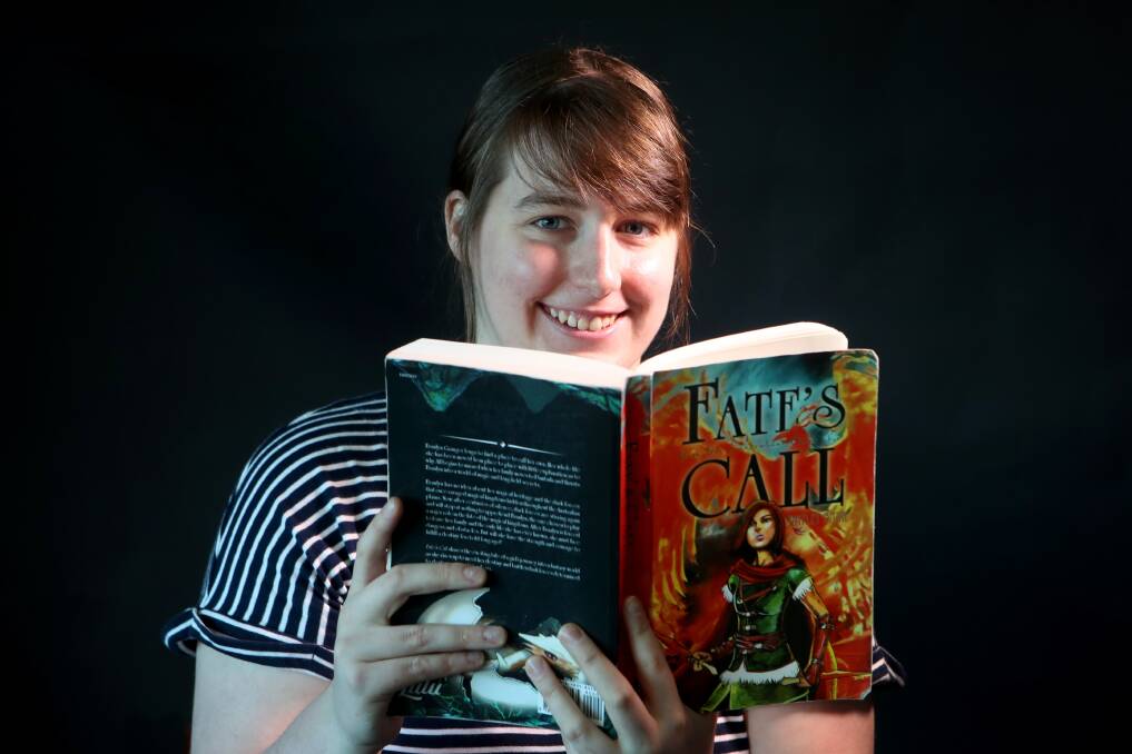 PERSISTENCE PAYS: Hayley Barr with her first novel, Fate's Call. Ms Barr spent the past decade writing and refining her book, before it was finally published. Picture: Sylvia Liber.
