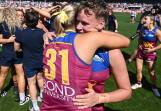 Dakota Davidson gets a hug from Brisbane Lions teammate Taylor Smith after the AFLW grand final. (Joel Carrett/AAP PHOTOS)