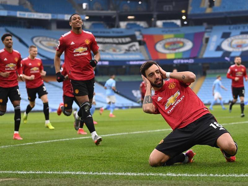 Bruno Fernandes celebrates his opening goal for Manchester United in their EPL derby win.