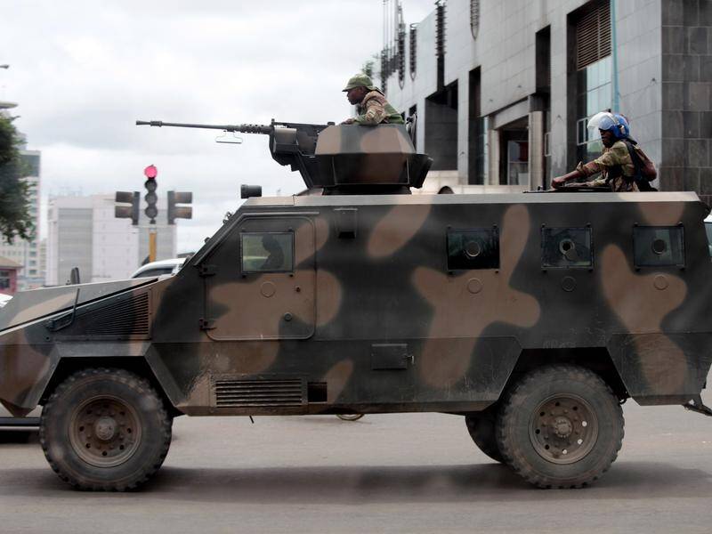 An armed Zimbabwean soldier on a street near a fuel station in the capital Harare.
