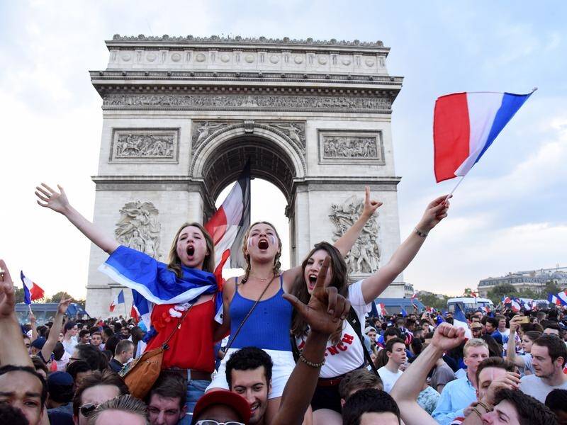 Fans celebrate France winning the World Cup outside the Champs Elysees.