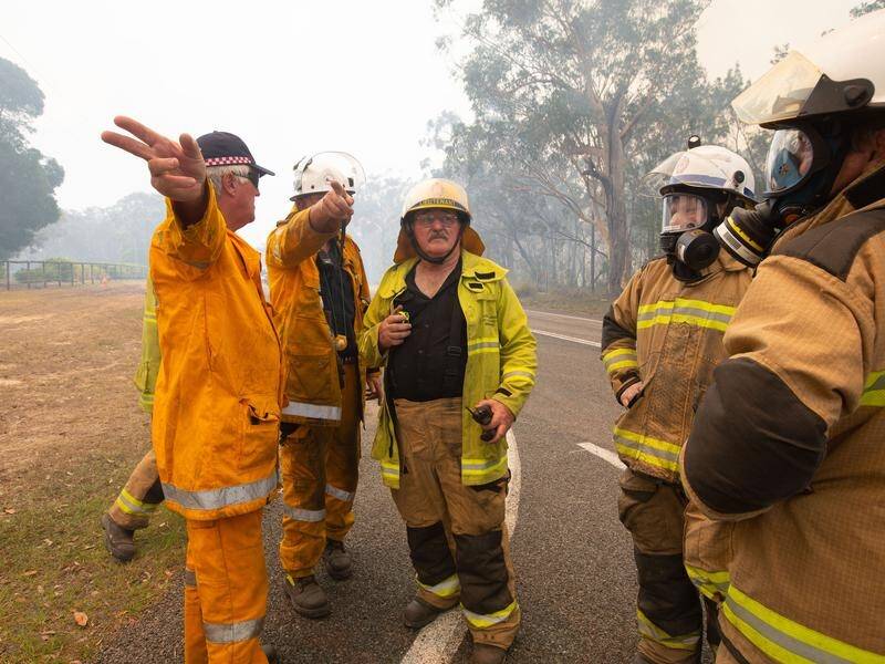 Calmer conditions may help firefighters battle more than 50 fires burning across Queensland.