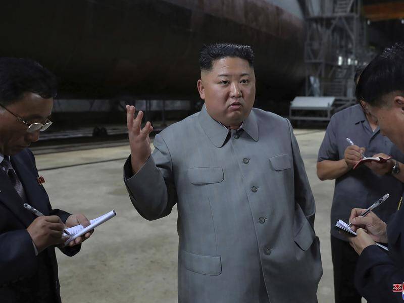 North Korean leader Kim Jong-un (C) inspecting a newly built submarine to be deployed soon.