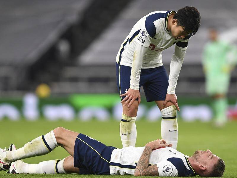 Spurs' Son Heung-min sees to Toby Alderweireld after he was injured against Manchester City.