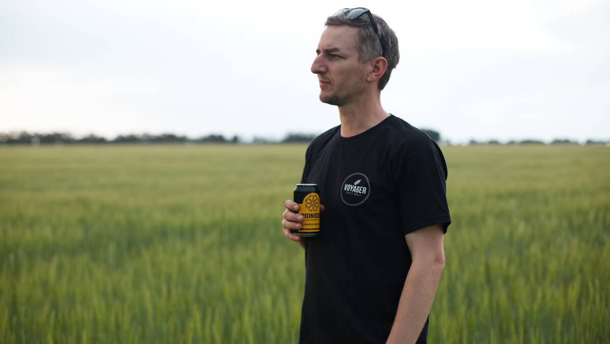 Voyager Craft Malt co-founder Stuart Whytcross examines a barley crop. PHOTO: Supplied