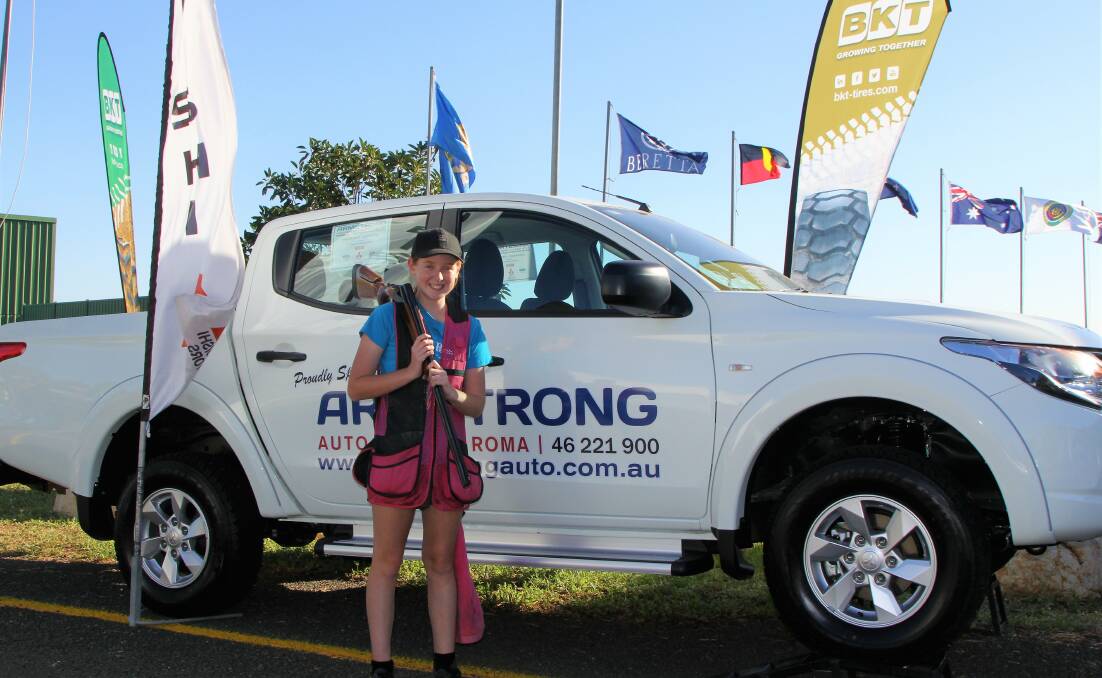 CHAMPION: Coleambally Clay Target Club C grade shooter, Chloe Evans, and the new car that she won during the nationals at Roma in Queensland.